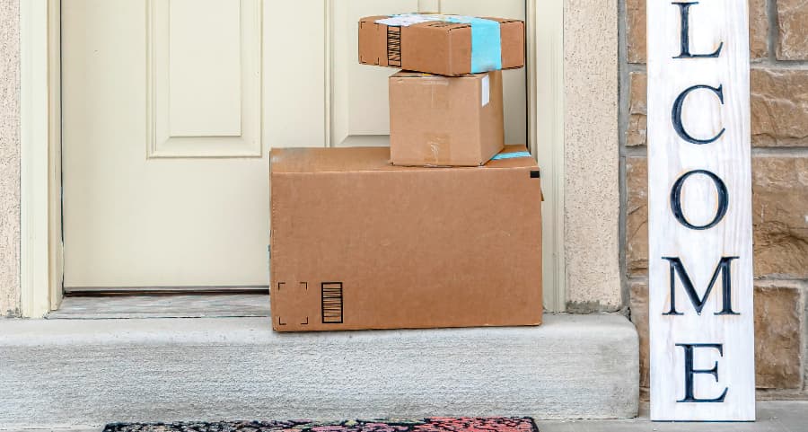 Deliveries on the front porch of a house with a welcome sign in Mansfield